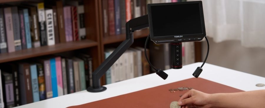 TOMLOV Autofocus 4K Digital Microscope with LED lights set up over a workspace for coin inspection.